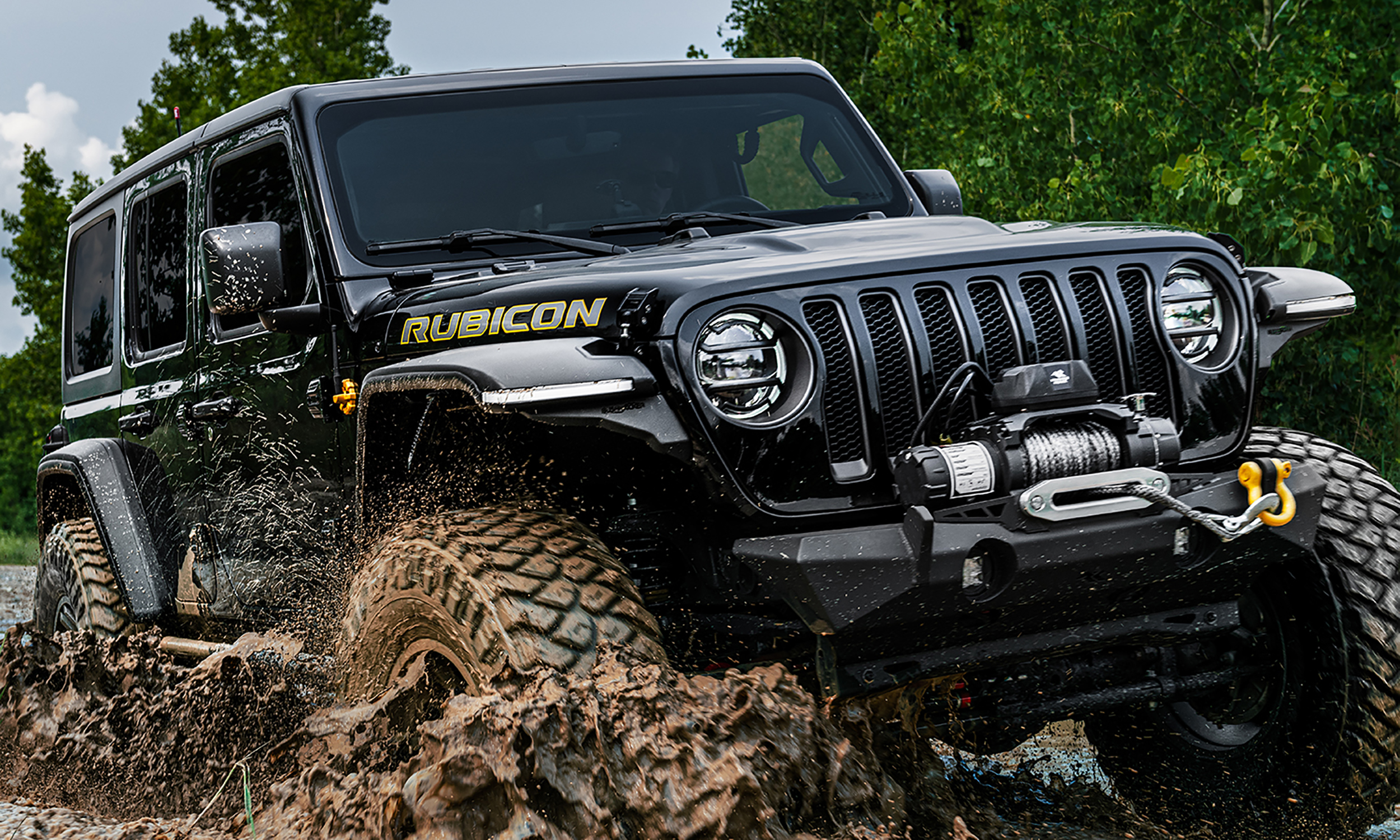 Jeep Wrangler with Bushwacker fender flares in muddy off-road