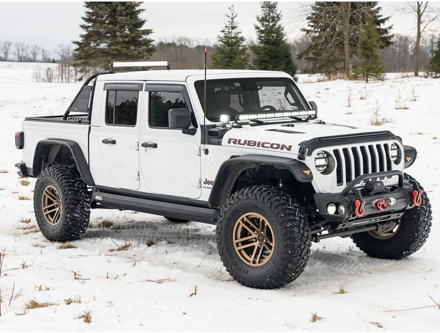 Jeep Gladiator with hood guard and window deflectors in snowy off-road